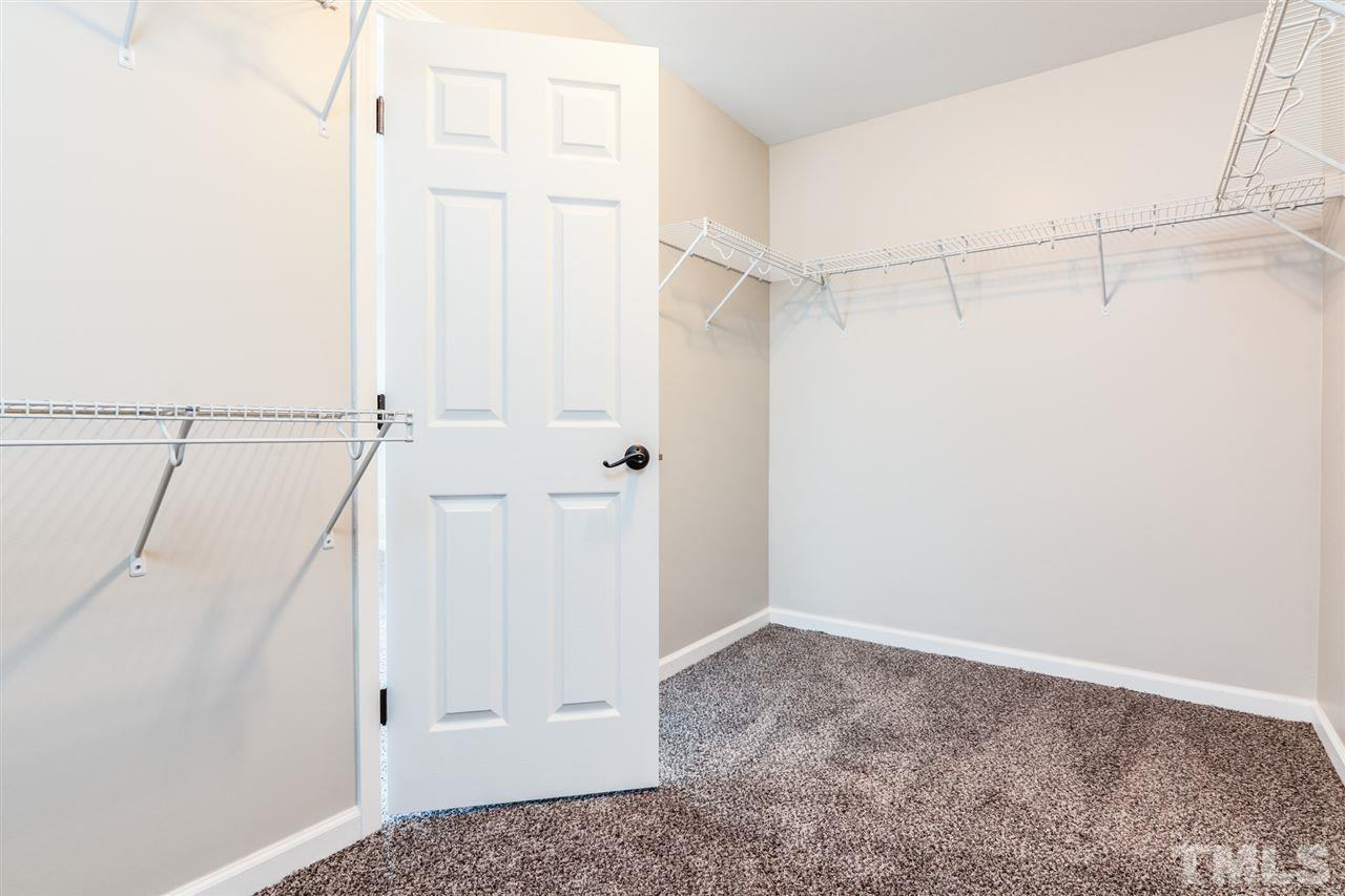 136 Ryder Cup Circle Raleigh, NC 27603 - Photo 11 of 17 a view of walk in closet with empty racks