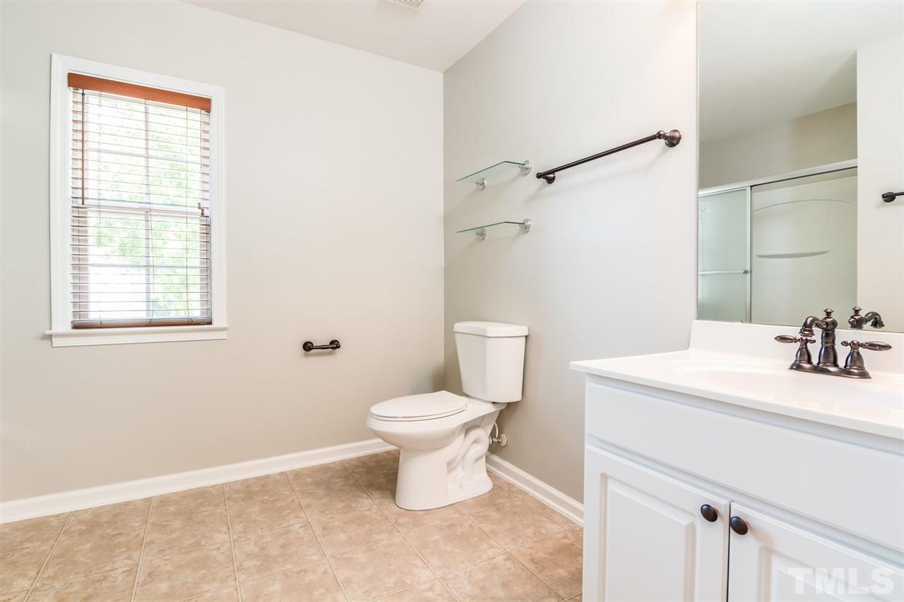 136 Ryder Cup Circle Raleigh, NC 27603 - Photo 14 of 17 a bathroom with a sink toilet and vanity