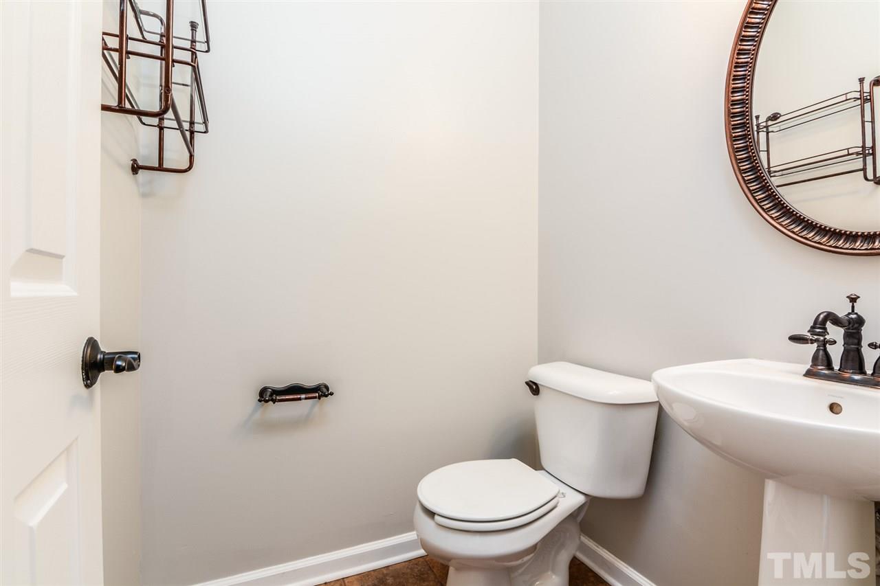 136 Ryder Cup Circle Raleigh, NC 27603 - Photo 15 of 17 a white toilet sitting next to a bathroom sink