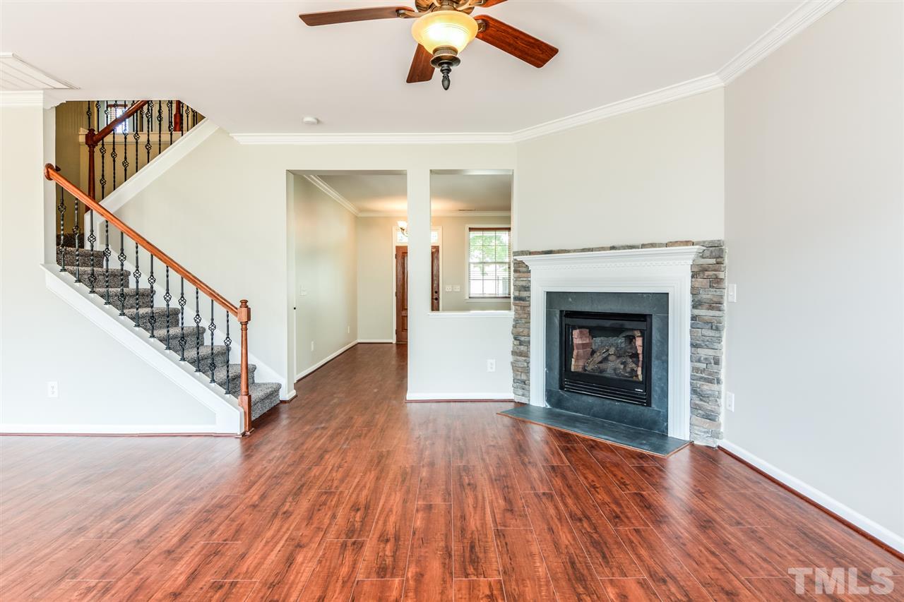 136 Ryder Cup Circle Raleigh, NC 27603 - Photo 3 of 17 a view of a livingroom with wooden floor a fireplace