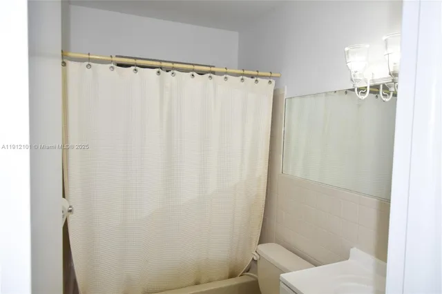 a bathroom with a shower and a toilet