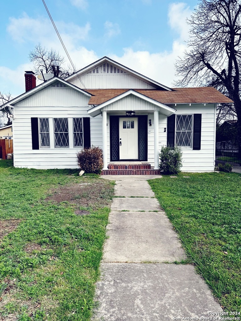 a front view of a house with a yard and porch