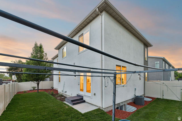 4595 College Ridge Court Millcreek, UT 84117 - Photo 38 of 57 Rear exterior featuring a manicured lawn, vinyl fencing, and a metal pergola structure