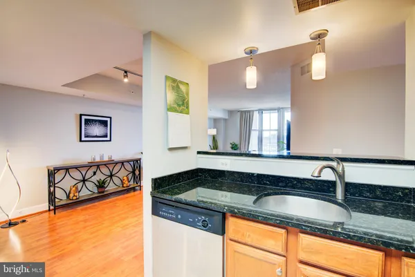 a bathroom with a granite countertop sink and a window