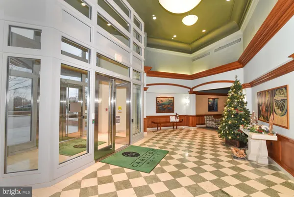 a lobby with furniture and a rug