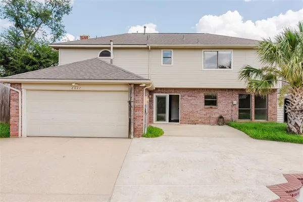 a front view of a house with garage