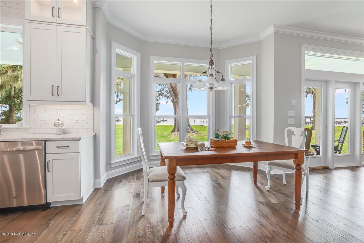 13056 Mandarin Road Jacksonville, FL 32223 - Photo 12 of 45 a living room with kitchen island granite countertop wooden floor and a chandelier