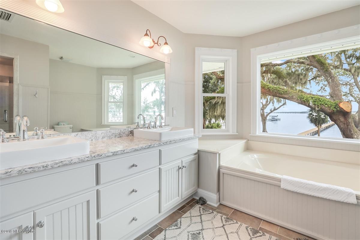 13056 Mandarin Road Jacksonville, FL 32223 - Photo 21 of 45 a bathroom with a granite countertop sink mirror double vanity and bathtub