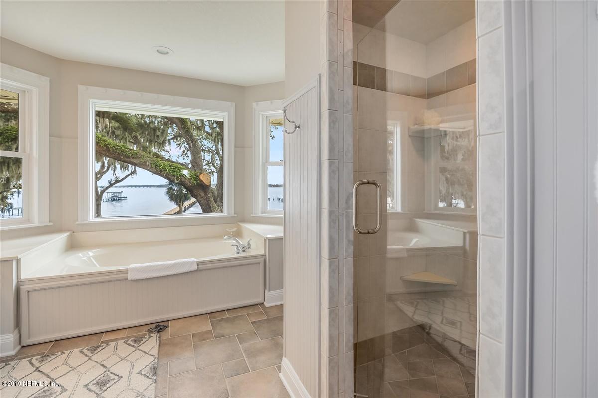 13056 Mandarin Road Jacksonville, FL 32223 - Photo 22 of 45 a bathroom with a bathtub and a shower