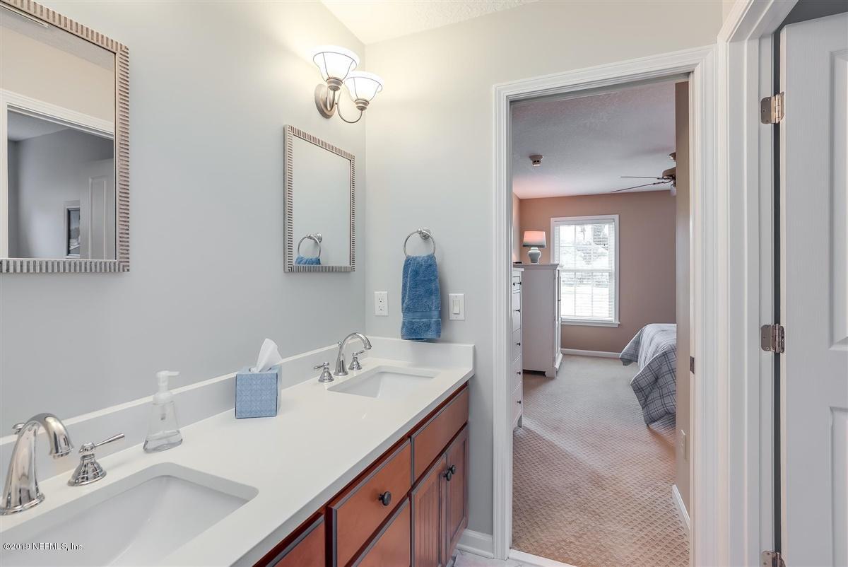 13056 Mandarin Road Jacksonville, FL 32223 - Photo 27 of 45 a en suite bathroom with a sink and a mirror