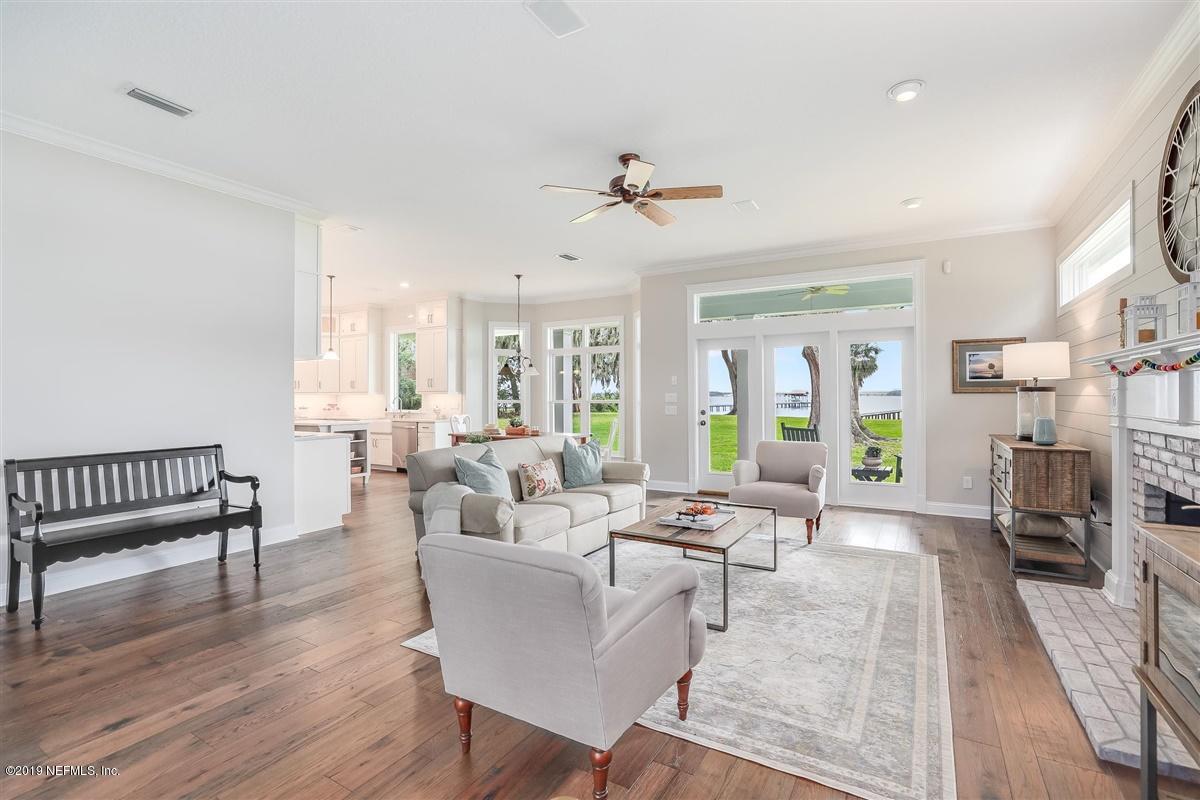 13056 Mandarin Road Jacksonville, FL 32223 - Photo 8 of 45 a living room with furniture dining table and a large window