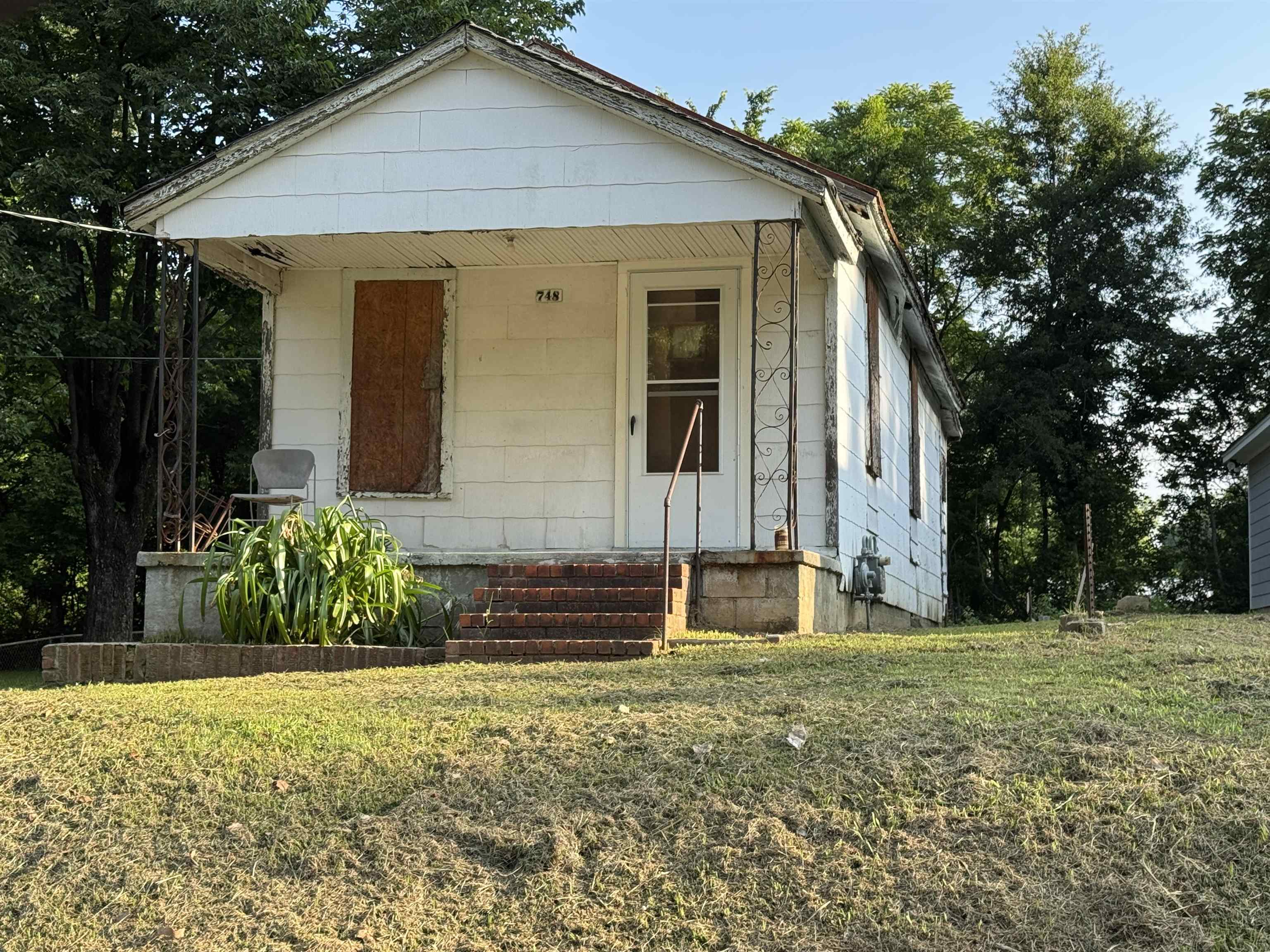 748 King Road Memphis, TN 38109 - Photo 2 of 4 White siding exterior with a covered front porch featuring wrought iron supports