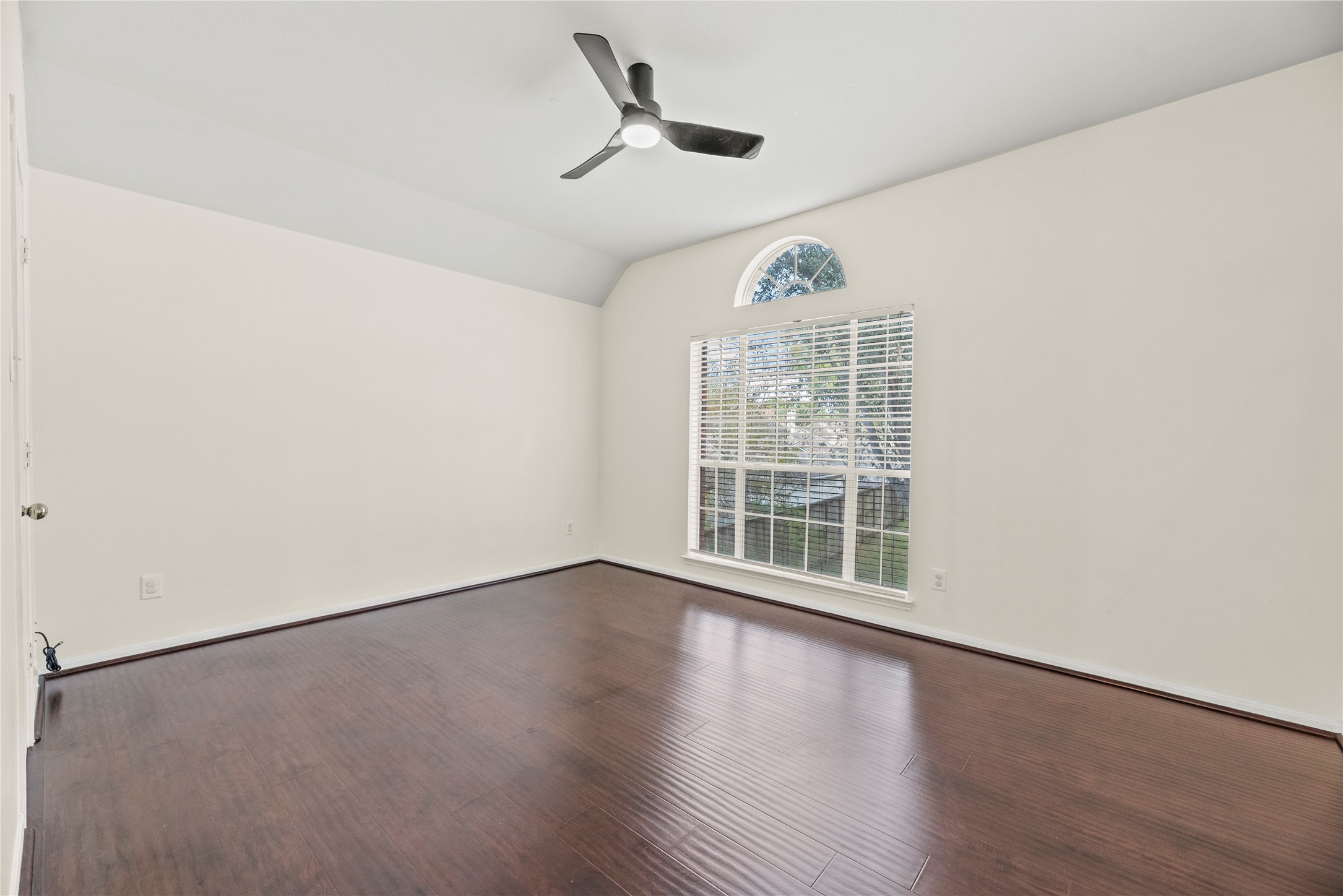 402 Spring Trace Court Houston, TX 77094 - Photo 25 of 35 an empty room with wooden floor ceiling fan and windows