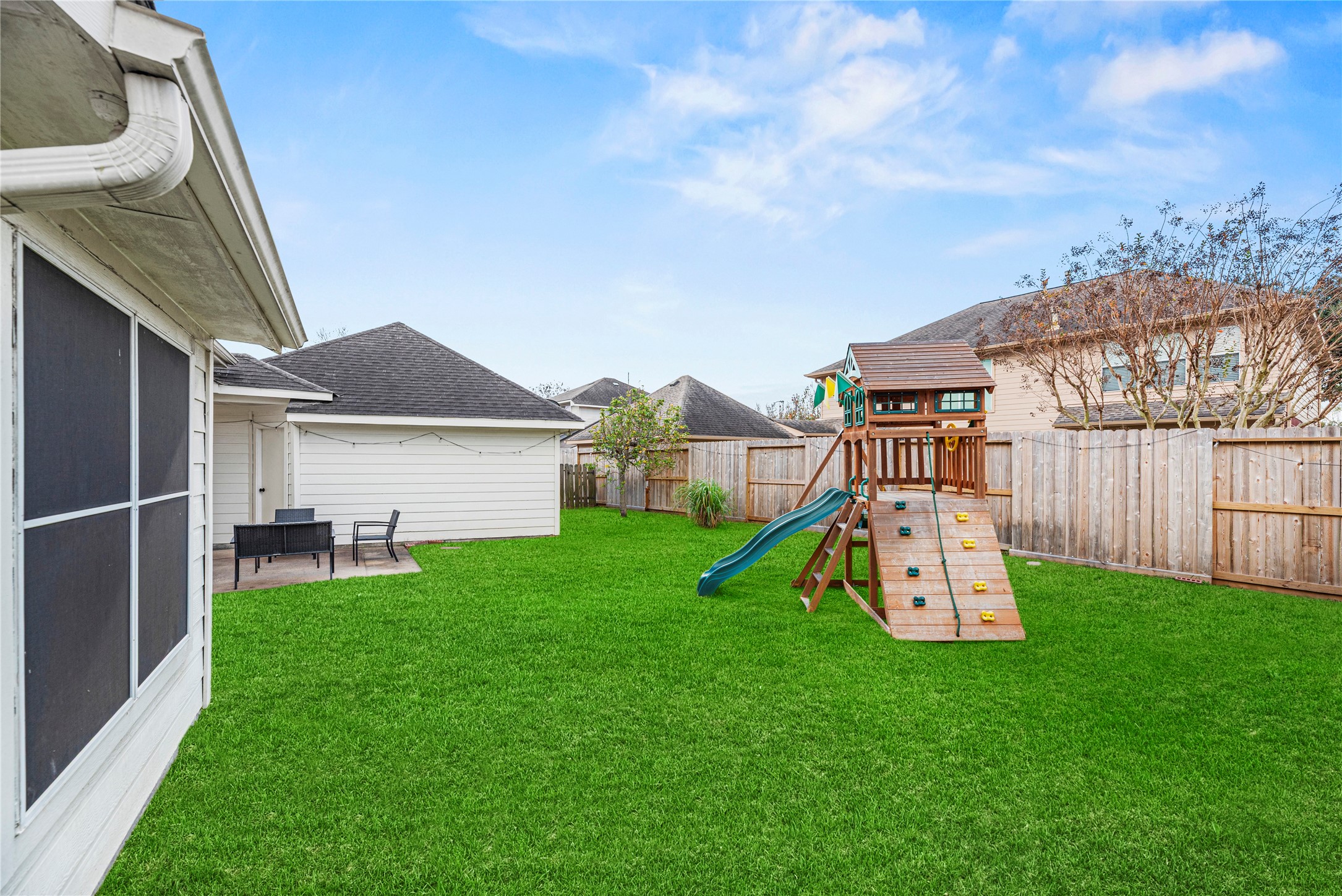 402 Spring Trace Court Houston, TX 77094 - Photo 30 of 35 a view of a backyard with a garden and deck