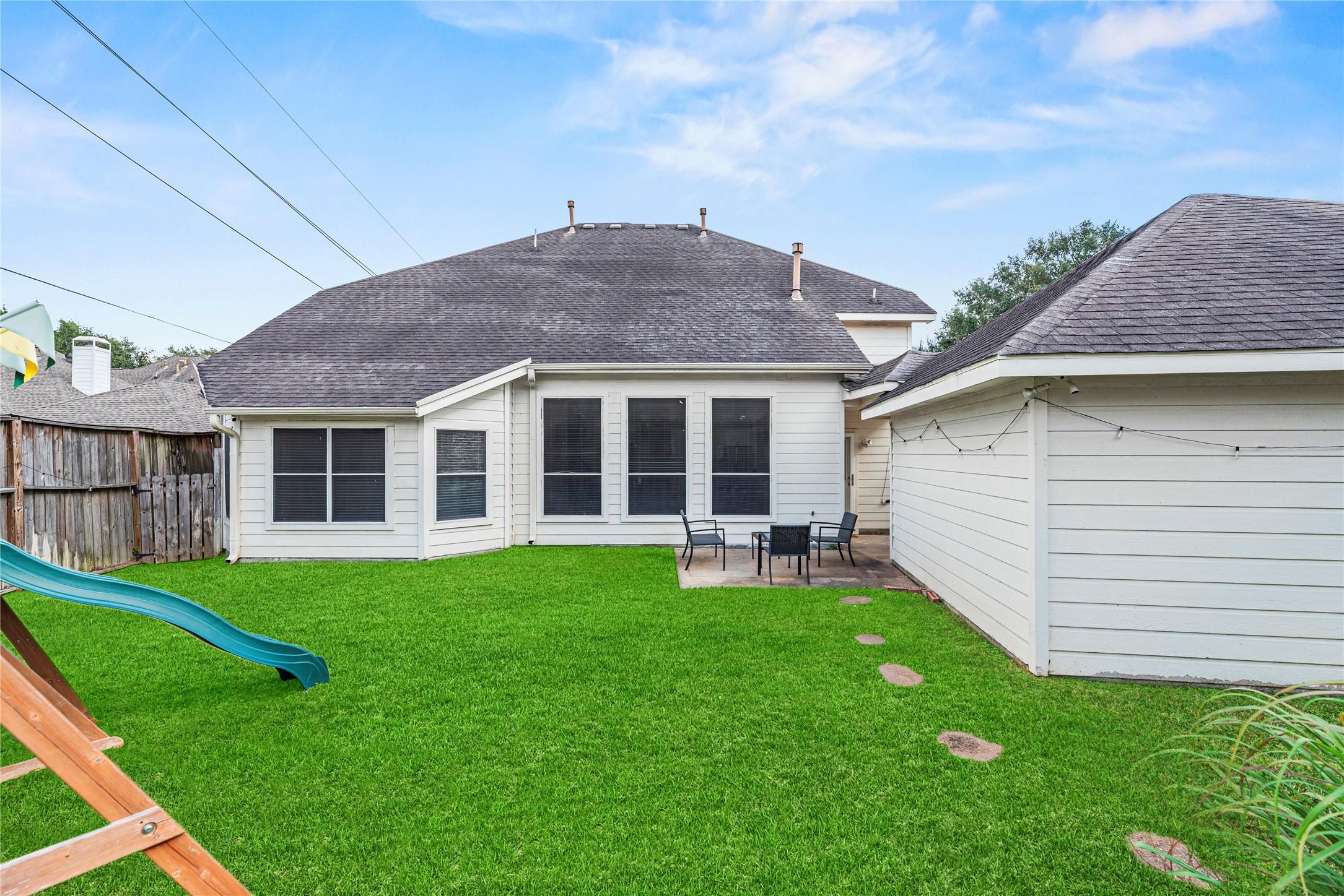 402 Spring Trace Court Houston, TX 77094 - Photo 32 of 35 a backyard of a house with table and chairs