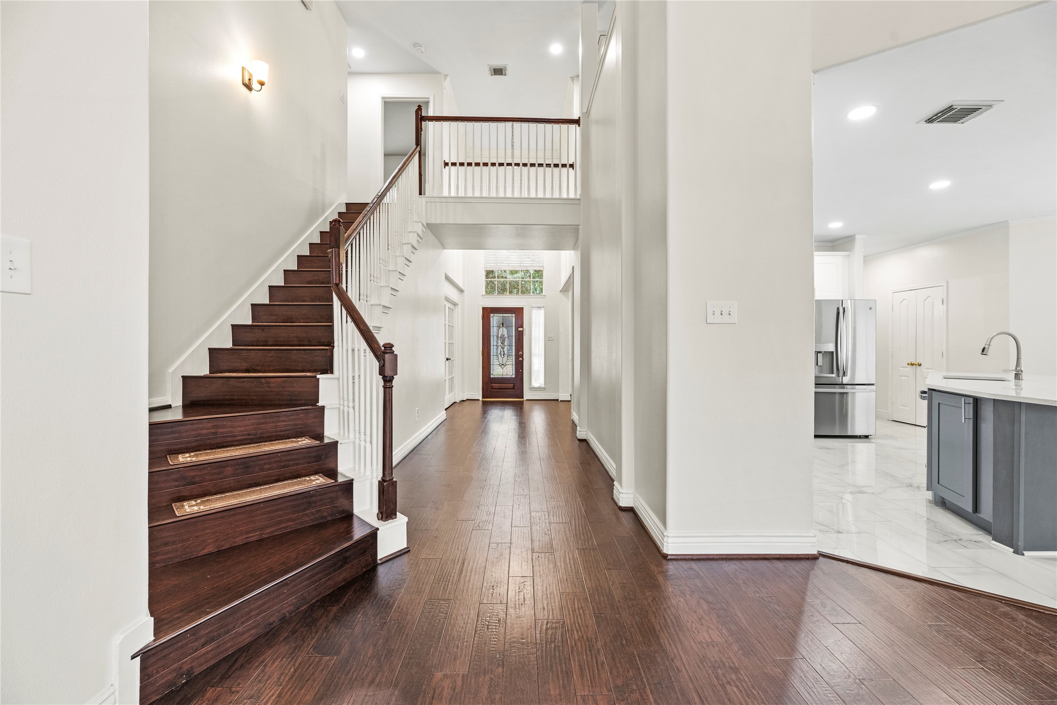 402 Spring Trace Court Houston, TX 77094 - Photo 6 of 35 a view of a hallway with wooden floor and staircase