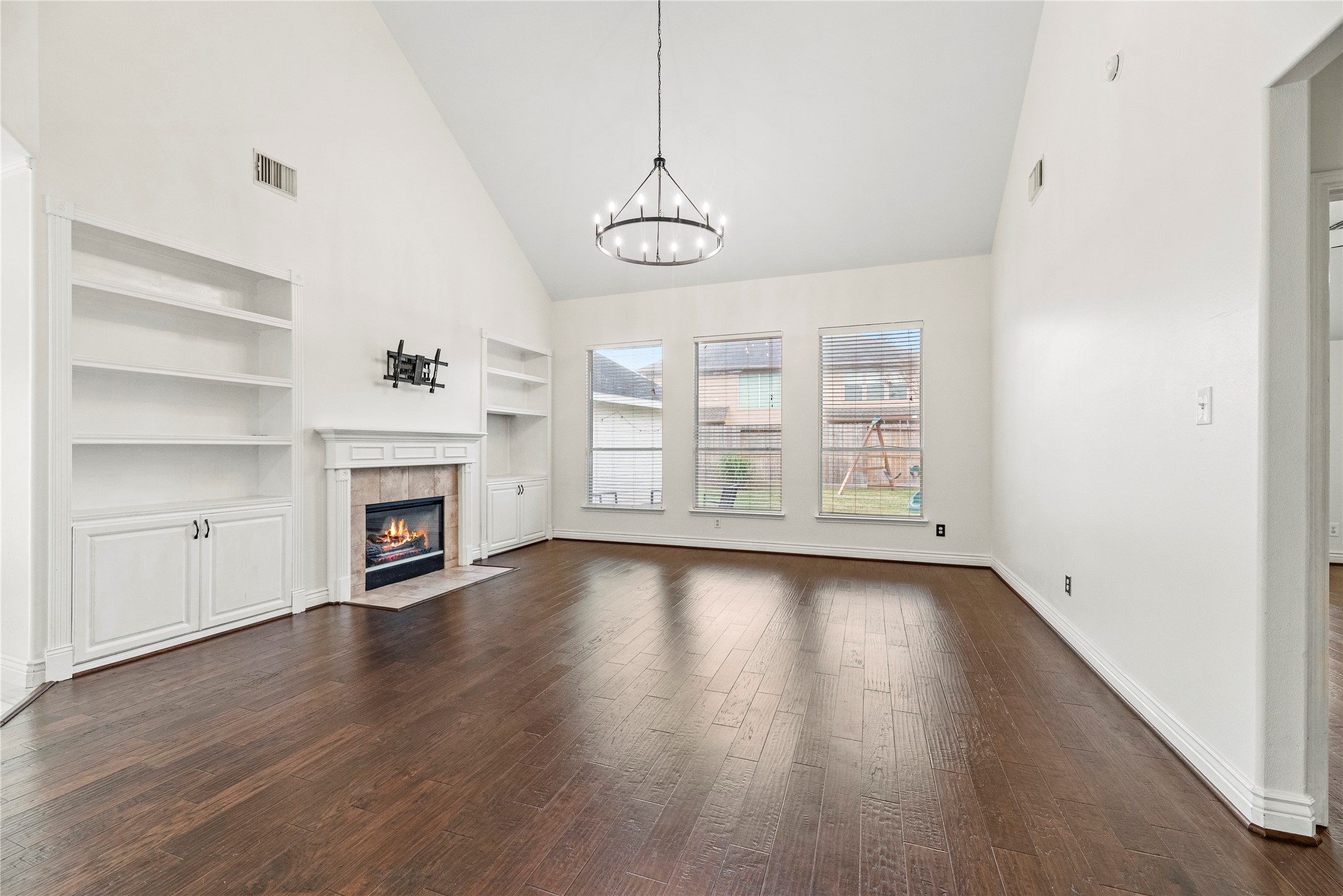 402 Spring Trace Court Houston, TX 77094 - Photo 7 of 35 a view of an empty room with wooden floor fireplace and a window