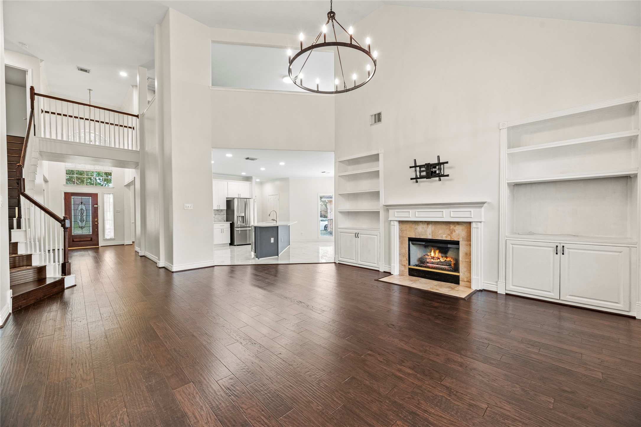 402 Spring Trace Court Houston, TX 77094 - Photo 8 of 35 a view of empty room with wooden floor and fireplace