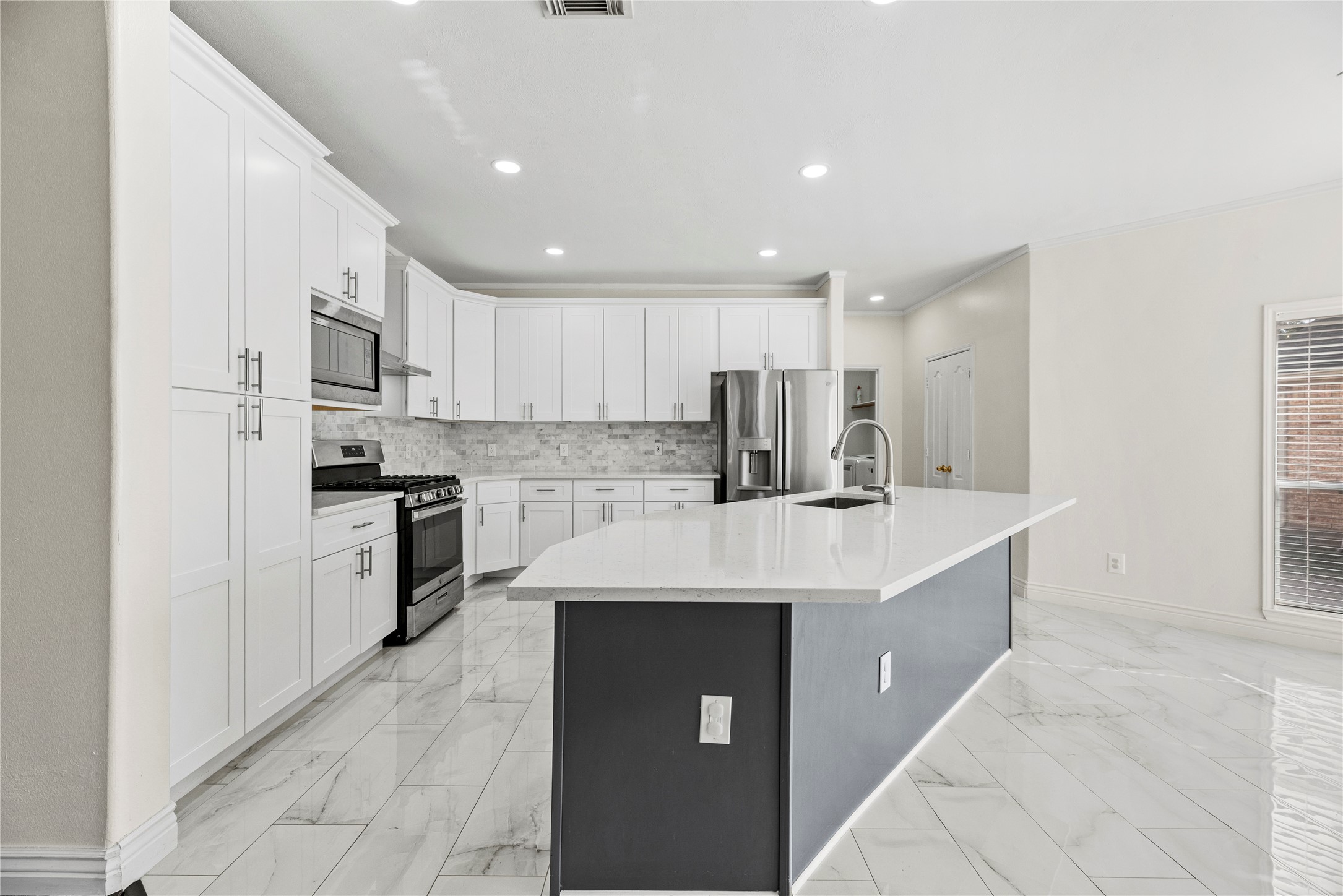 402 Spring Trace Court Houston, TX 77094 - Photo 10 of 35 a kitchen with stainless steel appliances kitchen island granite countertop a sink and a refrigerator