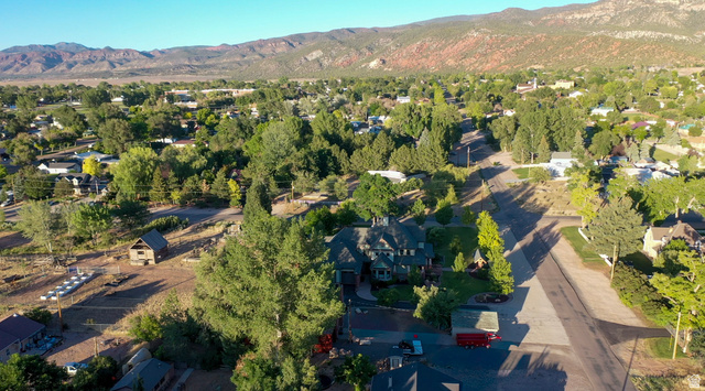 426 West Center Street Parowan, UT 84761 - Photo 100 of 107 Expansive property featuring a multi-level residence with extensive landscaping, a detached outbuilding, and mature trees