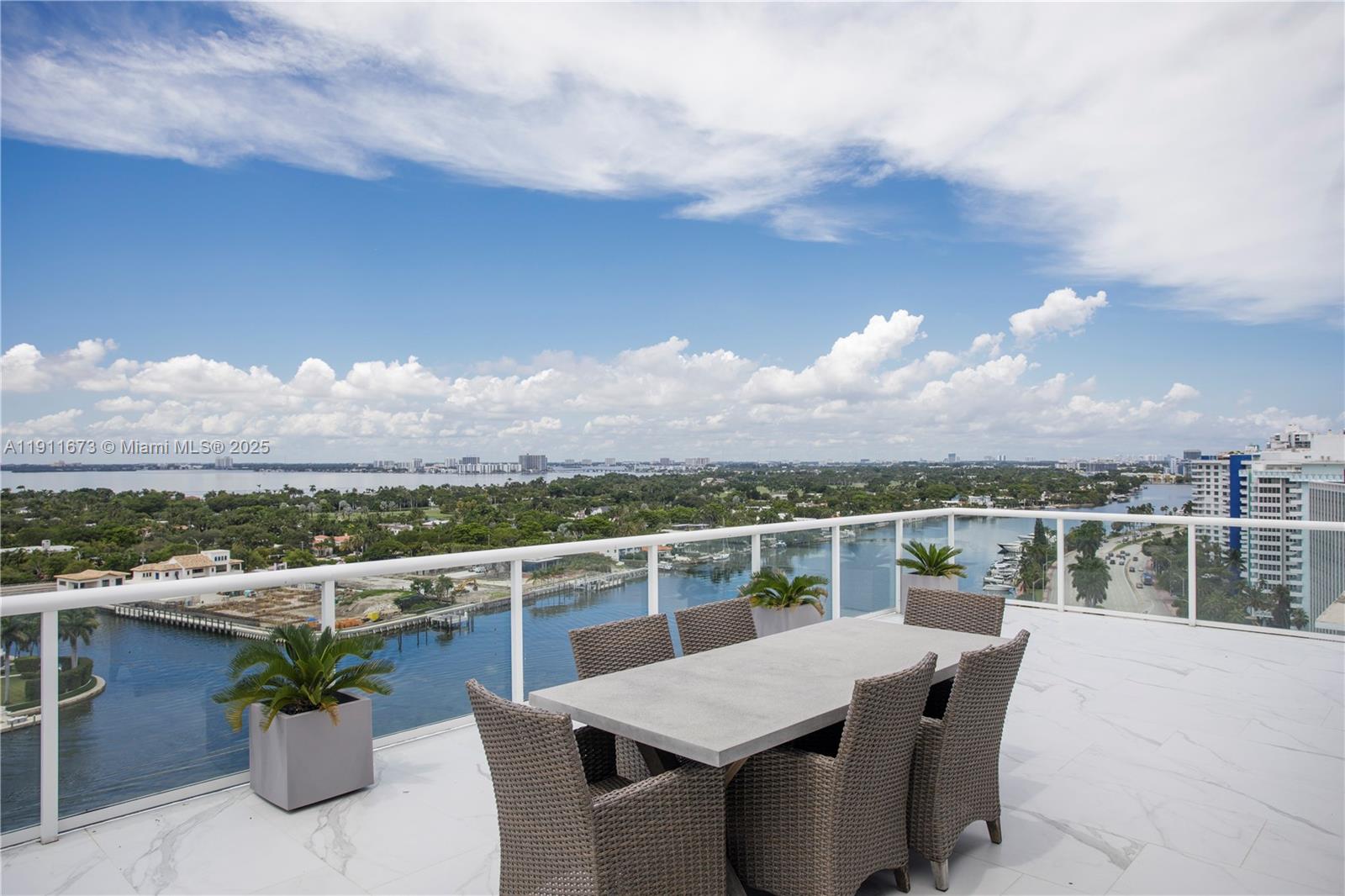 a view of a balcony dining table and chairs with wooden floor