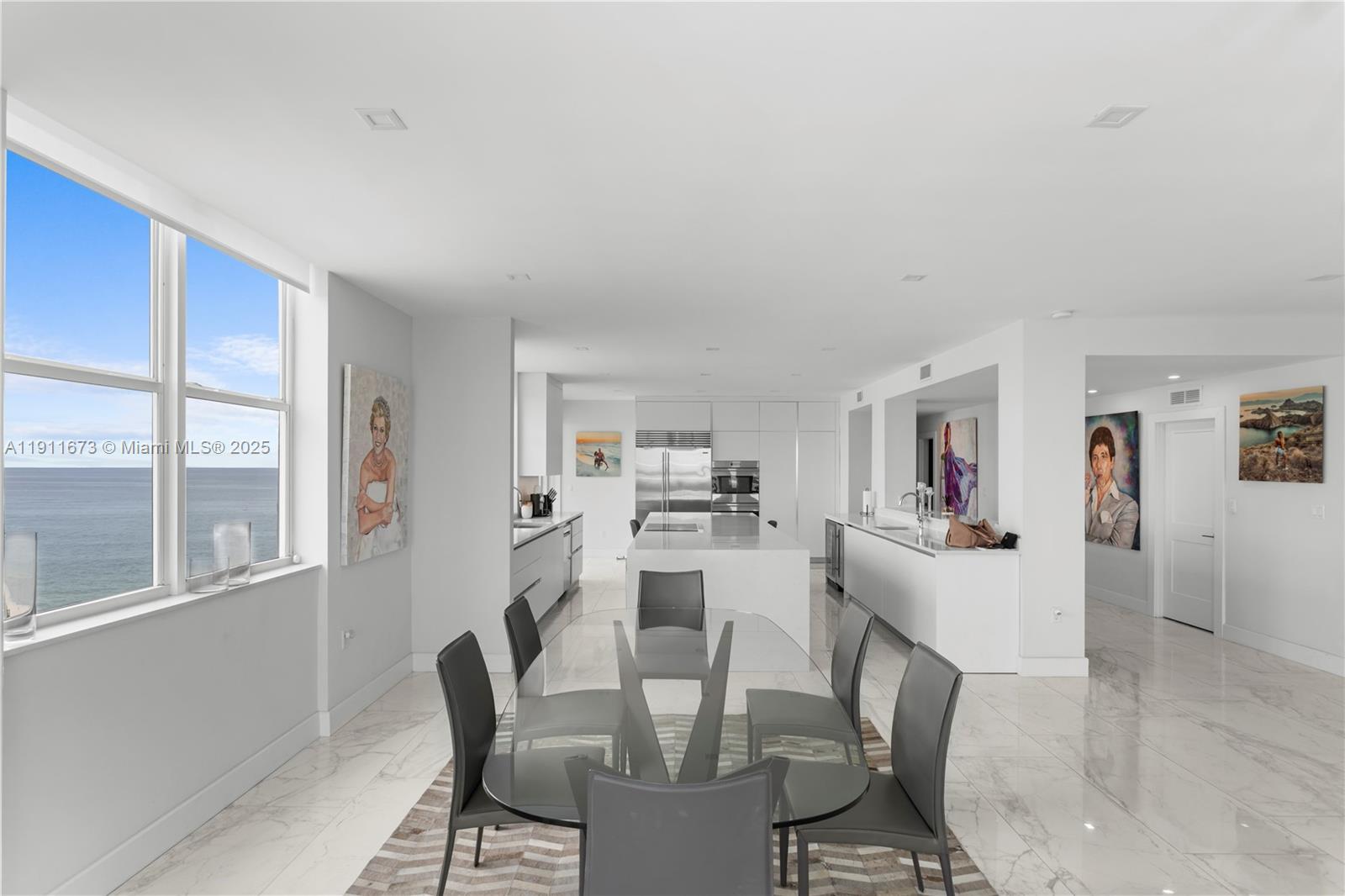 5001 Collins Avenue, Unit PH1 Miami Beach, FL 33140 - Photo 11 of 82 a view of a dining room with furniture window and wooden floor