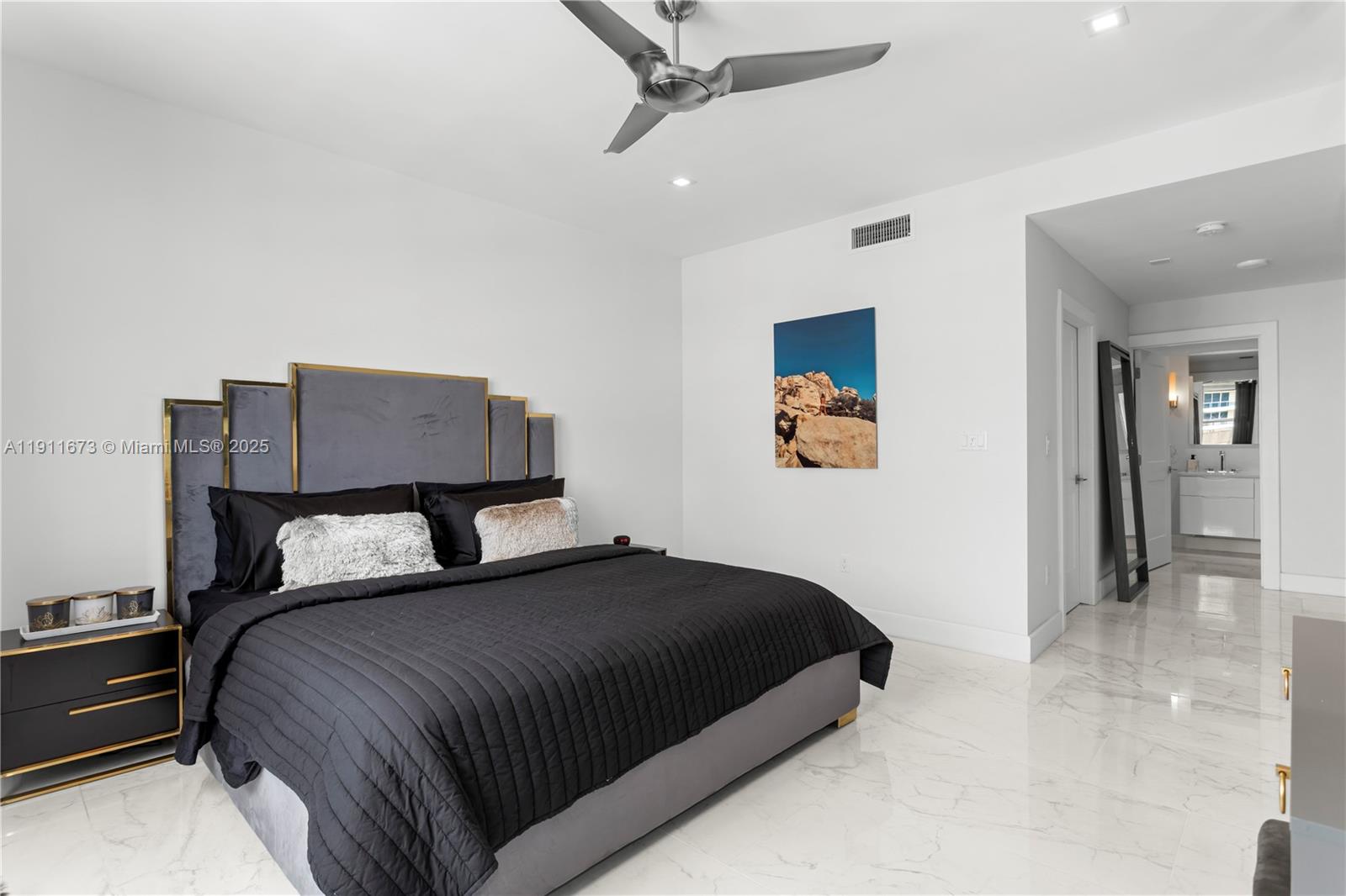5001 Collins Avenue, Unit PH1 Miami Beach, FL 33140 - Photo 23 of 82 a bedroom with a bed and a chandelier