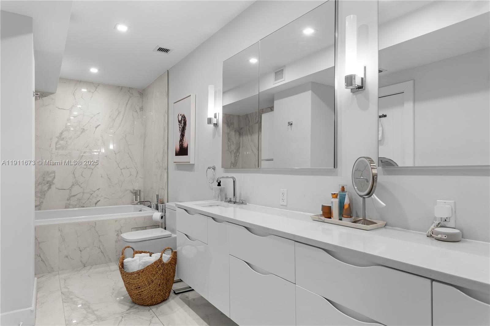 5001 Collins Avenue, Unit PH1 Miami Beach, FL 33140 - Photo 26 of 82 a bathroom with a tub sink and mirror