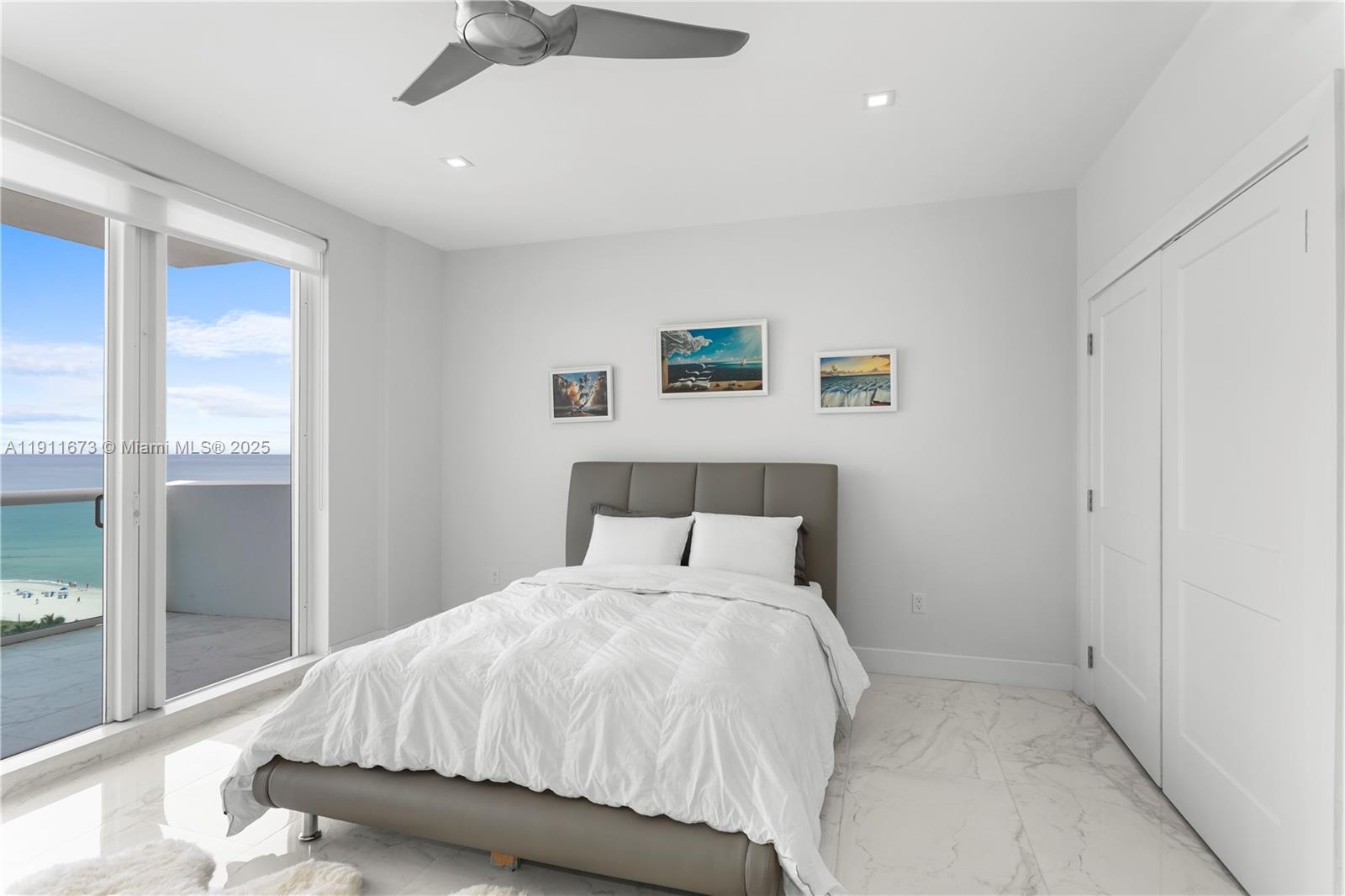 5001 Collins Avenue, Unit PH1 Miami Beach, FL 33140 - Photo 29 of 82 a bedroom with a large bed and a chandelier