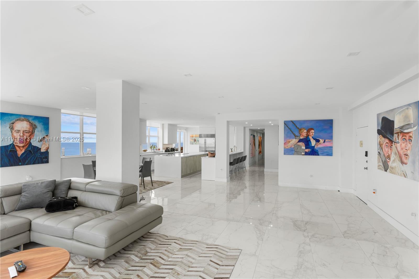 5001 Collins Avenue, Unit PH1 Miami Beach, FL 33140 - Photo 3 of 82 a living room with furniture and a view of kitchen
