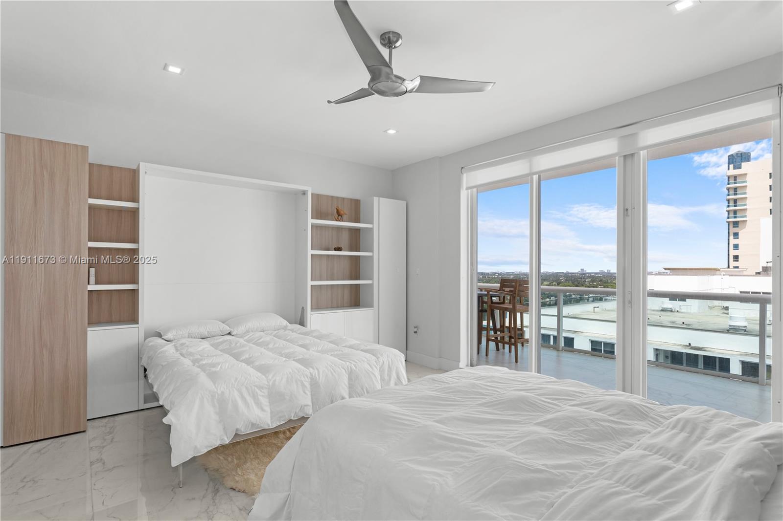 5001 Collins Avenue, Unit PH1 Miami Beach, FL 33140 - Photo 32 of 82 a bedroom with a large bed and a large window