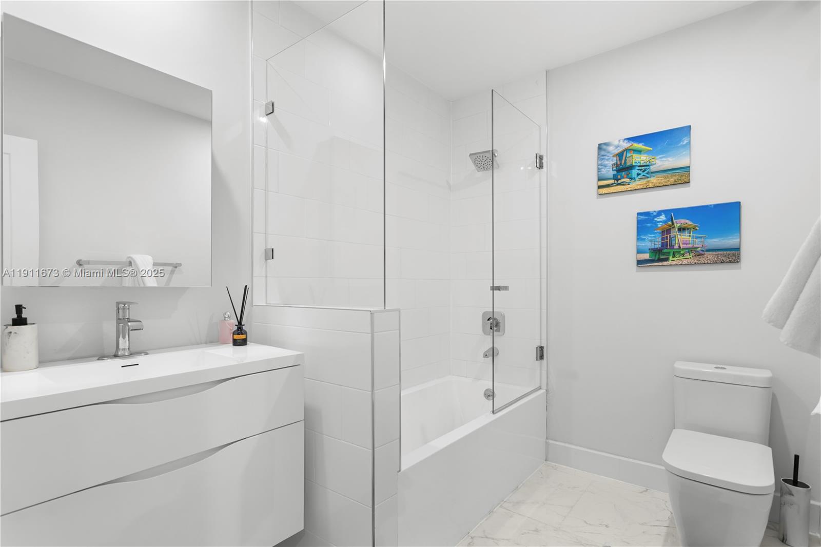 5001 Collins Avenue, Unit PH1 Miami Beach, FL 33140 - Photo 34 of 82 a bathroom with a sink a toilet and shower