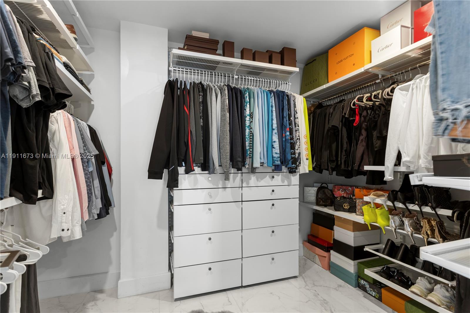 5001 Collins Avenue, Unit PH1 Miami Beach, FL 33140 - Photo 36 of 82 a view of walk in closet with clothes and shoes