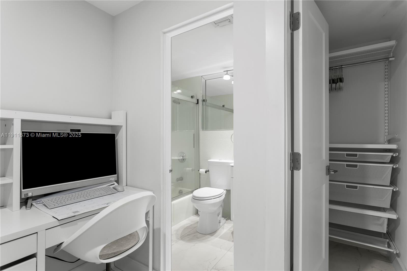 5001 Collins Avenue, Unit PH1 Miami Beach, FL 33140 - Photo 38 of 82 a bathroom with a toilet a sink and a mirror