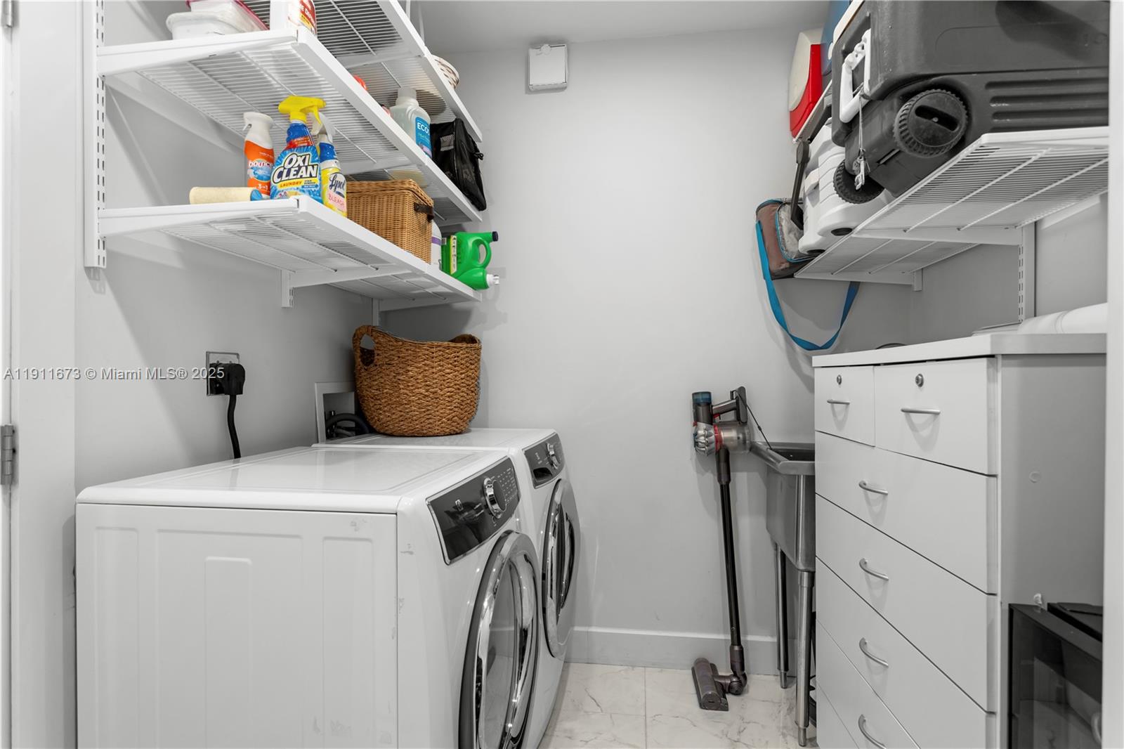 5001 Collins Avenue, Unit PH1 Miami Beach, FL 33140 - Photo 40 of 82 a utility room with dryer and washer