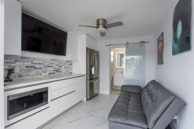 a living room with furniture and a floor to ceiling window