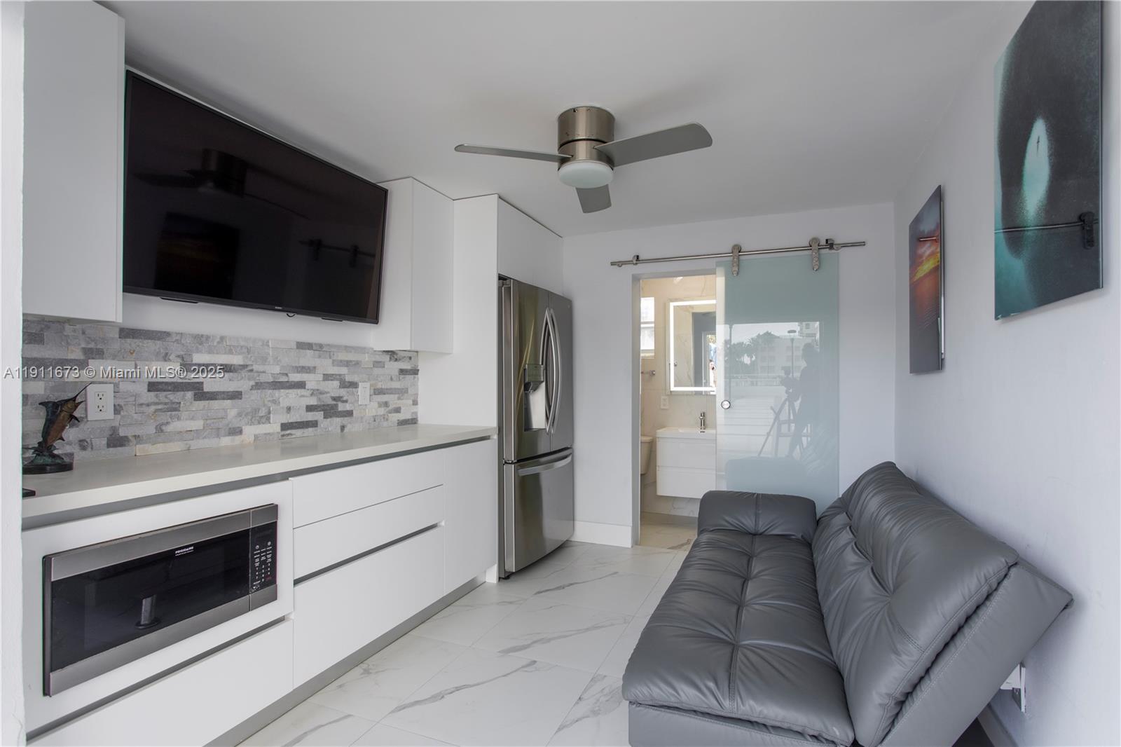 5001 Collins Avenue, Unit PH1 Miami Beach, FL 33140 - Photo 5 of 82 a living room with stainless steel appliances kitchen island granite countertop furniture and a fireplace
