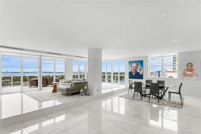 a living room with furniture and a dining table with wooden floor