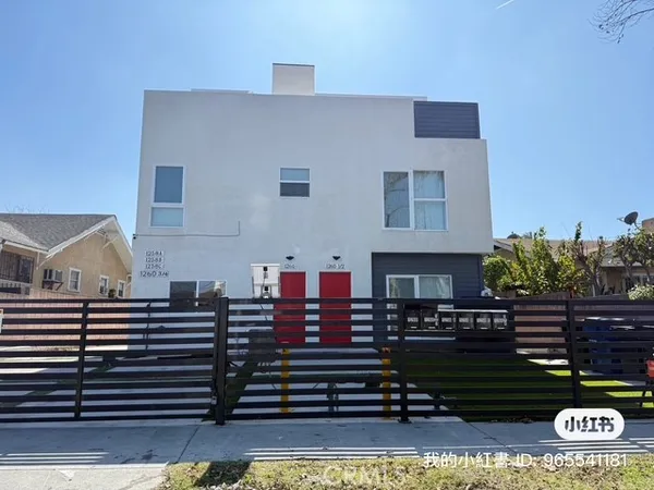 a view of a house with wooden fence