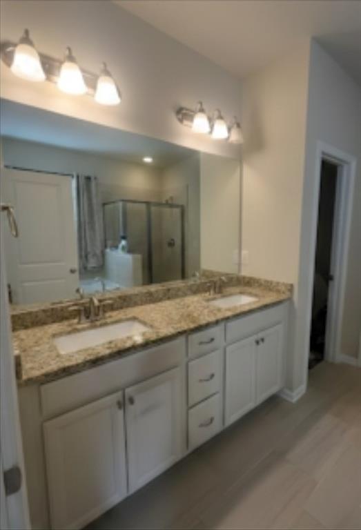 2595 Jupiter Drive Southwest Powder Springs, GA 30127 - Photo 18 of 26 a bathroom with a granite countertop double vanity sink and a mirror