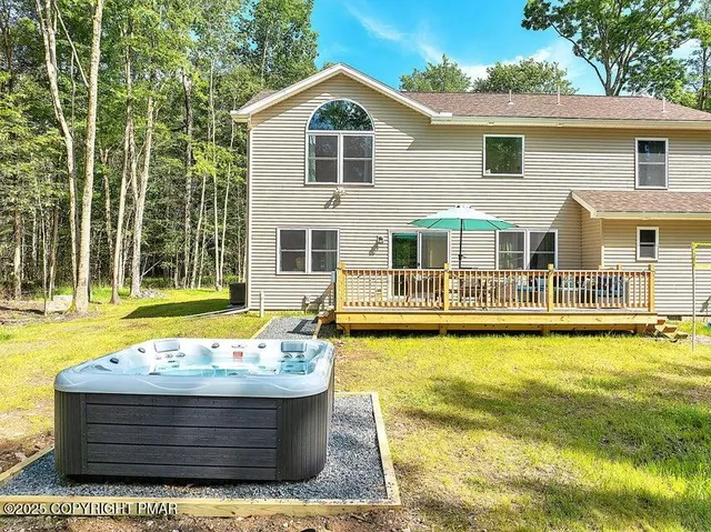 a view of roof deck with table and chairs