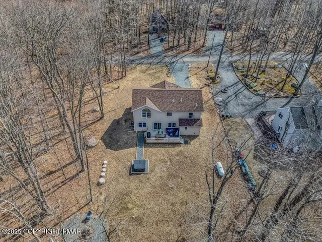 a swimming pool with outdoor seating and yard