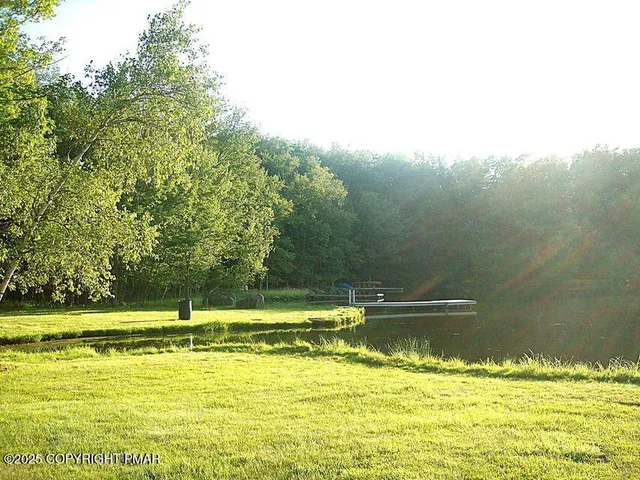 a view of a lake with a wooden fence