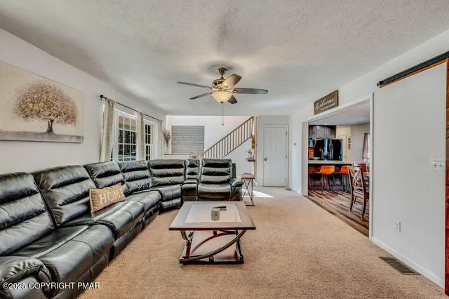 a living room with furniture and white walls