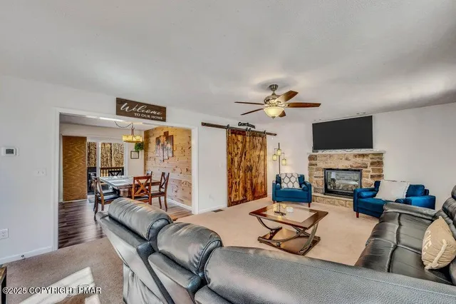 a living room with furniture and a fireplace