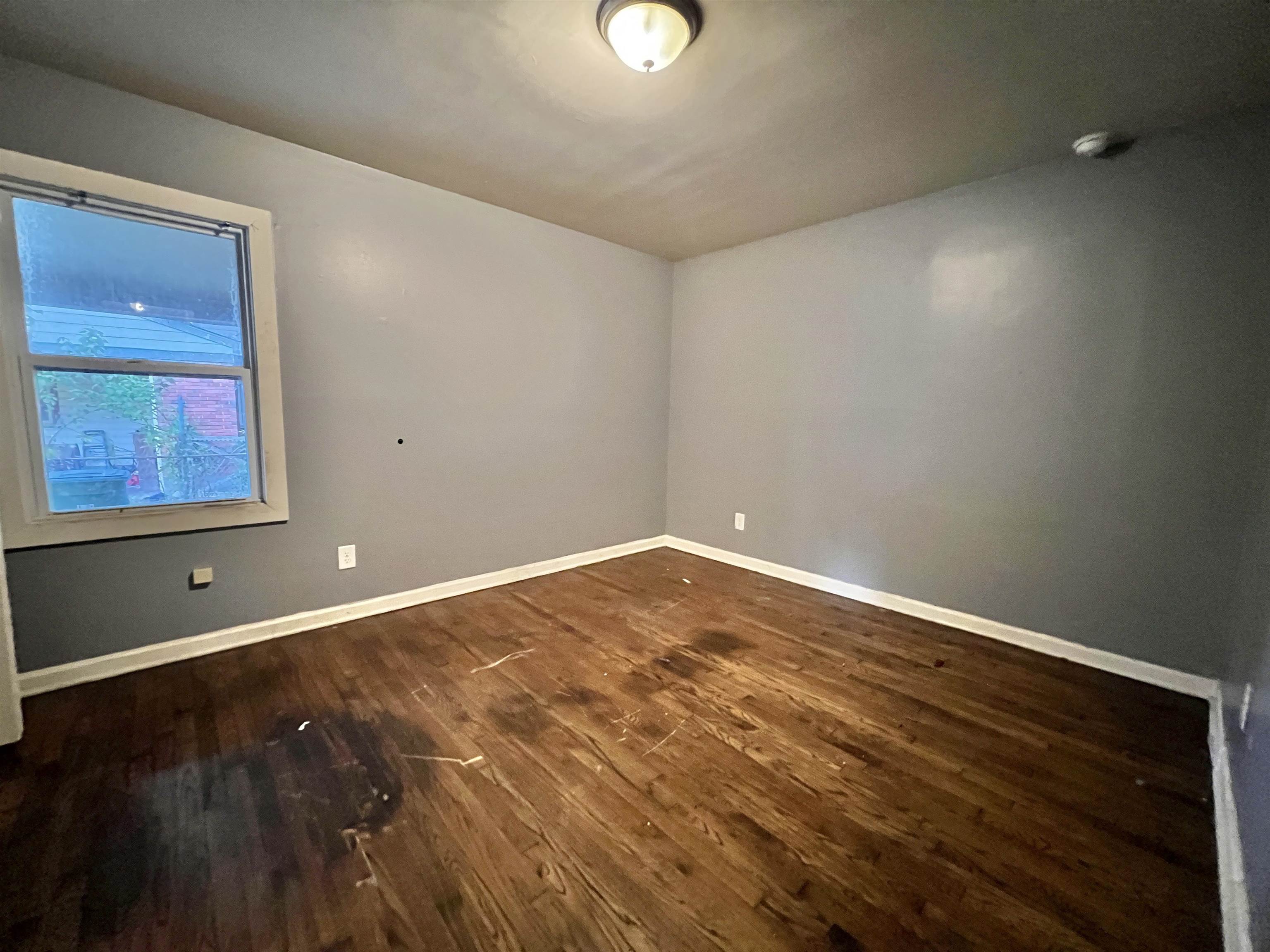 3804 Cazassa Road Memphis, TN 38116 - Photo 13 of 17 Empty room with dark wood-style flooring and baseboards