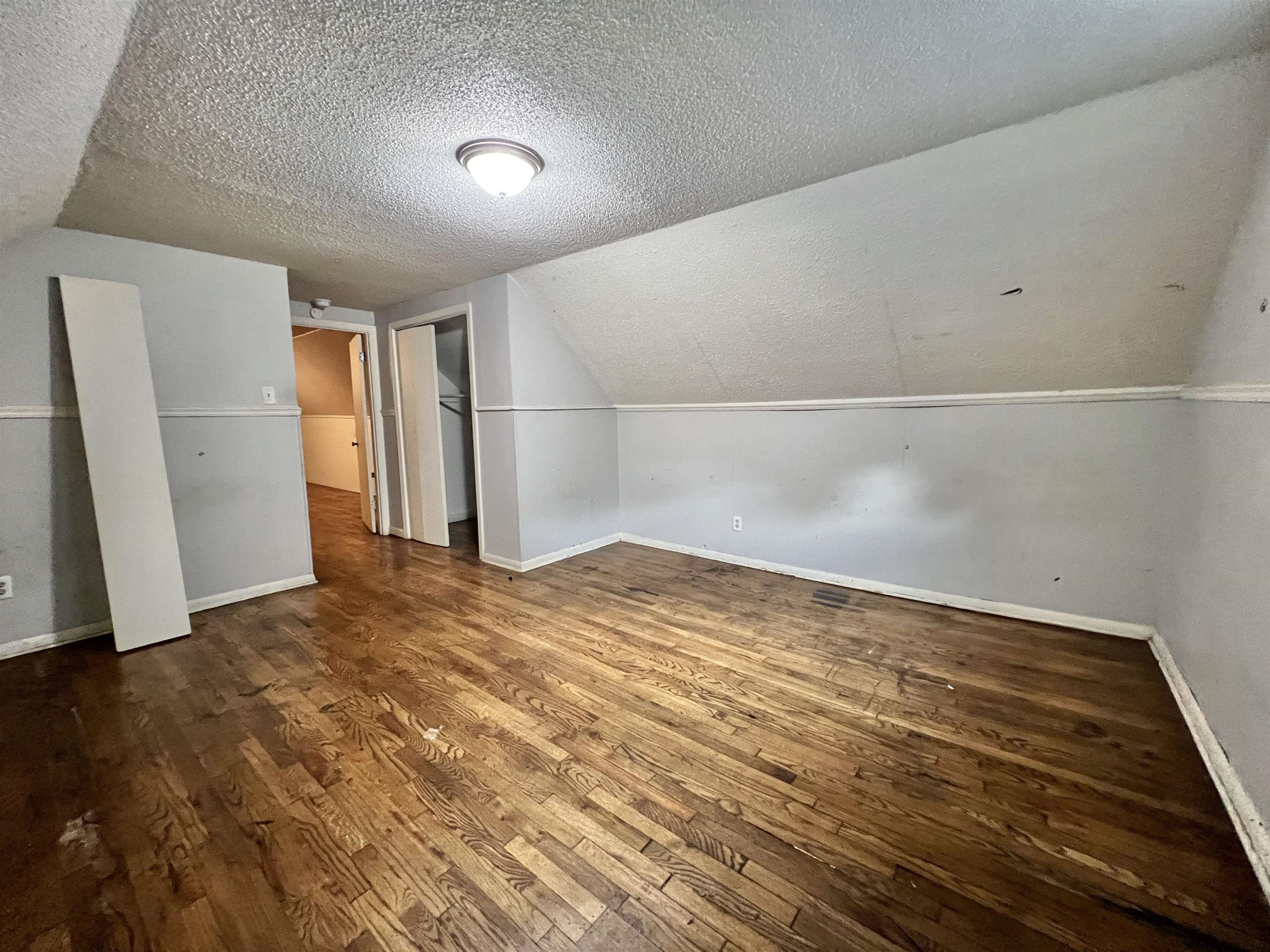 3804 Cazassa Road Memphis, TN 38116 - Photo 14 of 17 Bonus room with dark wood-style flooring, a textured ceiling, and vaulted ceiling