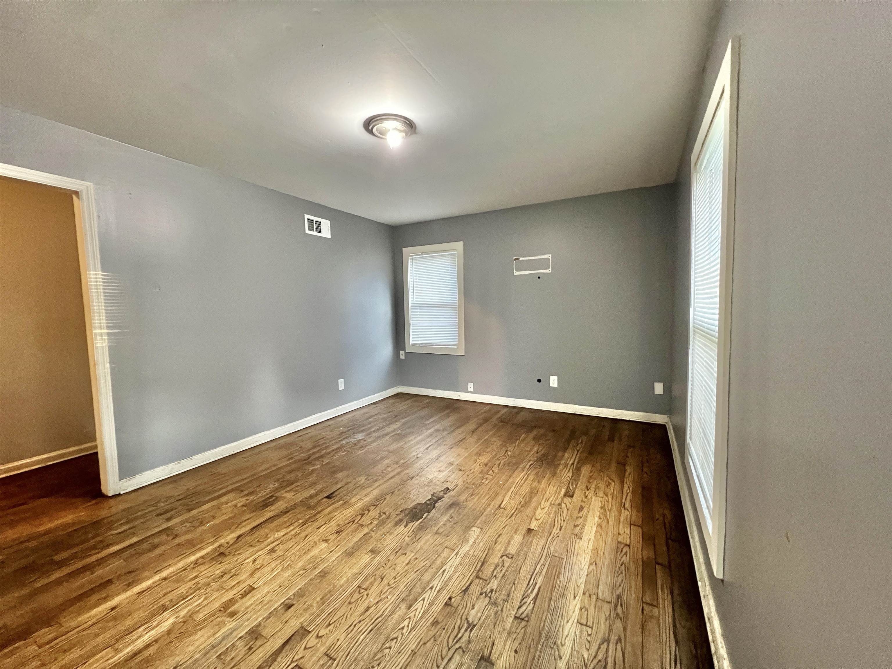3804 Cazassa Road Memphis, TN 38116 - Photo 2 of 17 Spare room featuring dark wood-style floors and plenty of natural light