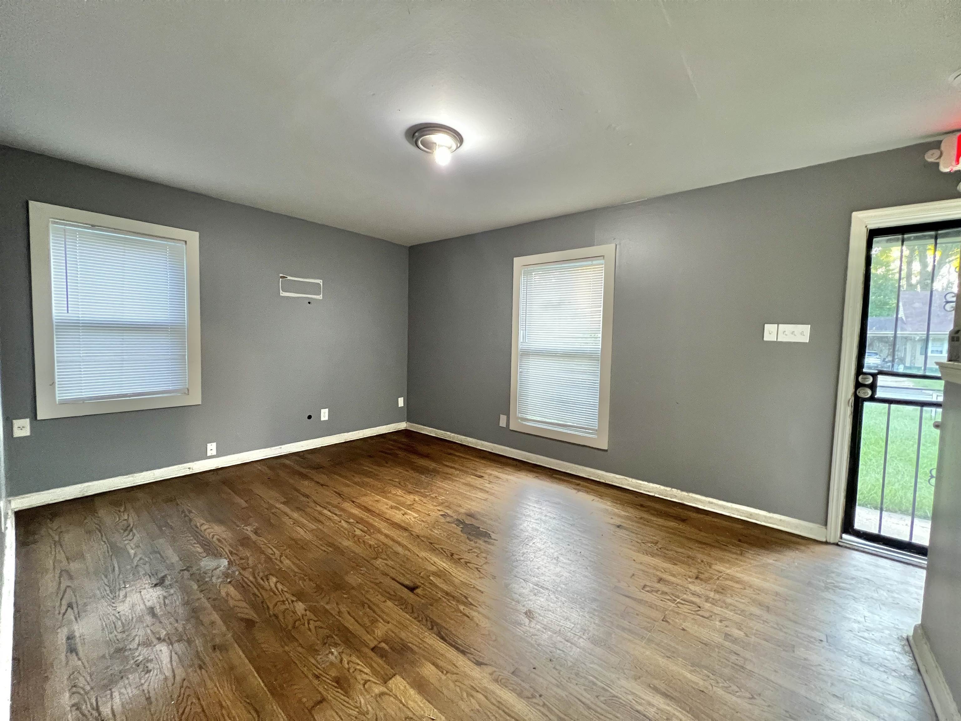 3804 Cazassa Road Memphis, TN 38116 - Photo 3 of 17 Spare room with healthy amount of natural light and dark wood-type flooring