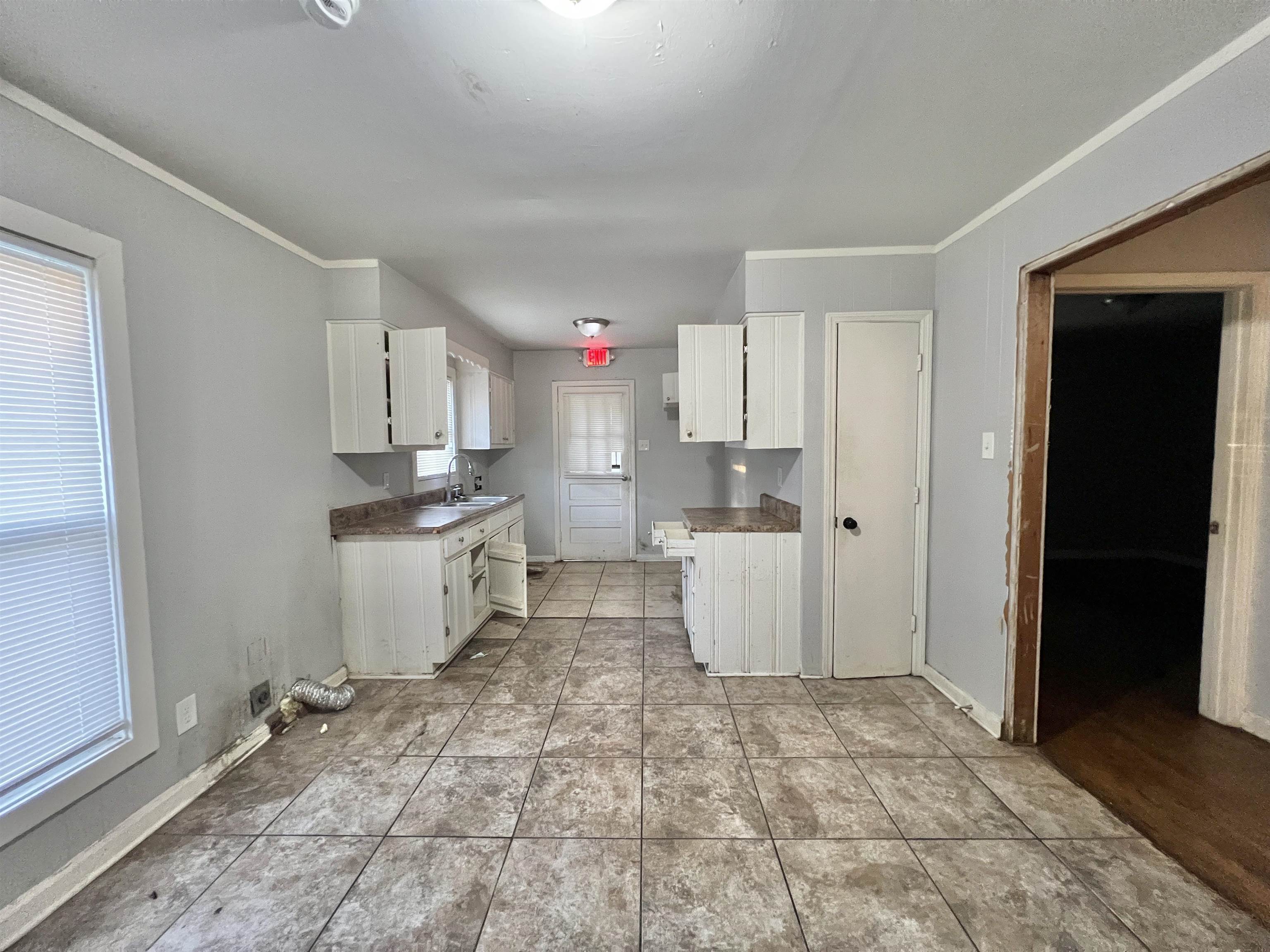 3804 Cazassa Road Memphis, TN 38116 - Photo 4 of 17 Kitchen with crown molding, white cabinetry, and light countertops